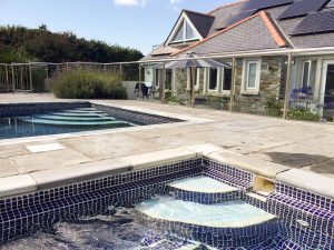 Outdoor heated swimming pool at Tadpoles, a self-catering beach house in Trevone Bay, Cornwall