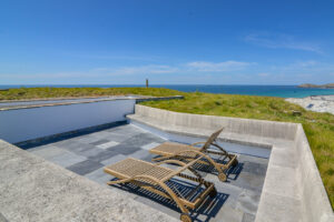 Sun loungers on the roof terrace with the sea in the background
